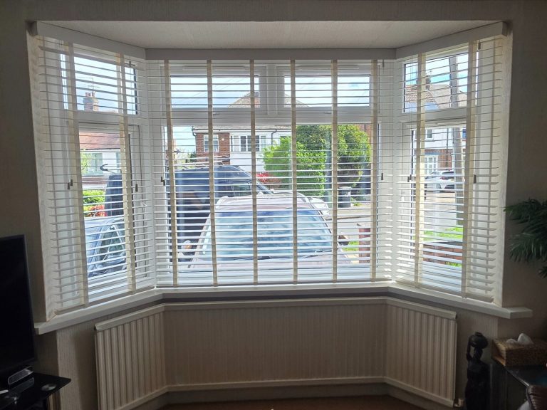Made to measure wooden venetian blinds Wooden taped venetian blinds expertly installed into a bay window recess