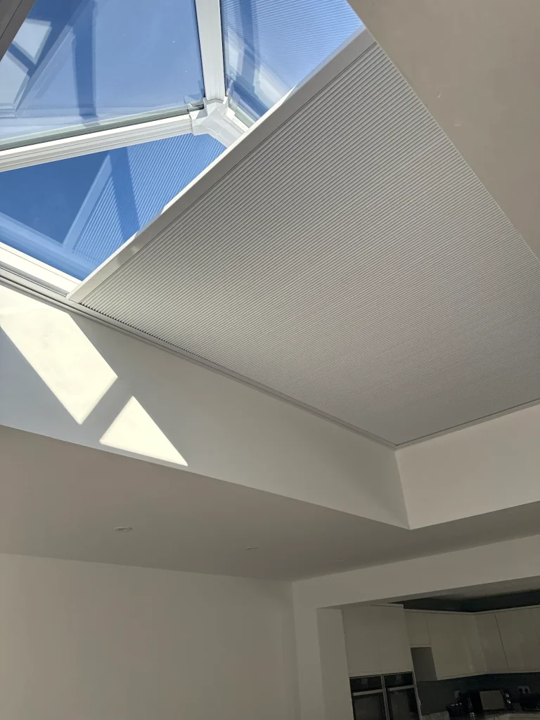 Solar Powered Roof Lantern Blind | TrueShade Interiors Made-to-measure solar powered roof lantern blind partially extended to reduce sunlight and glare in a home in Corby, Northamptonshire.
