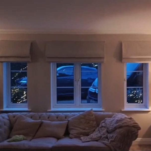 Motorised Roman blind Alt text: Made to measure motorised roman blinds installed in a bay window by TrueShade Interiors