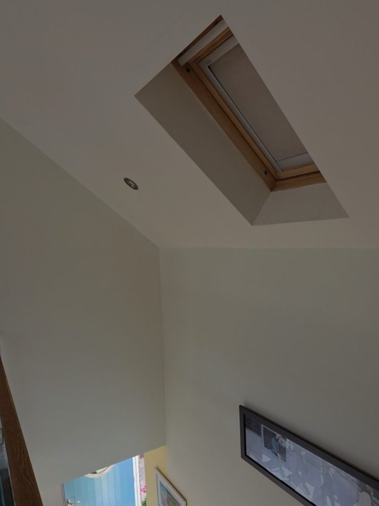 Solar VELUX Roof Window Blind | TrueShade Interiors Solar powered VELUX blind fitted to a high-level roof window in a sloping ceiling in Great Oxendon, Northamptonshire