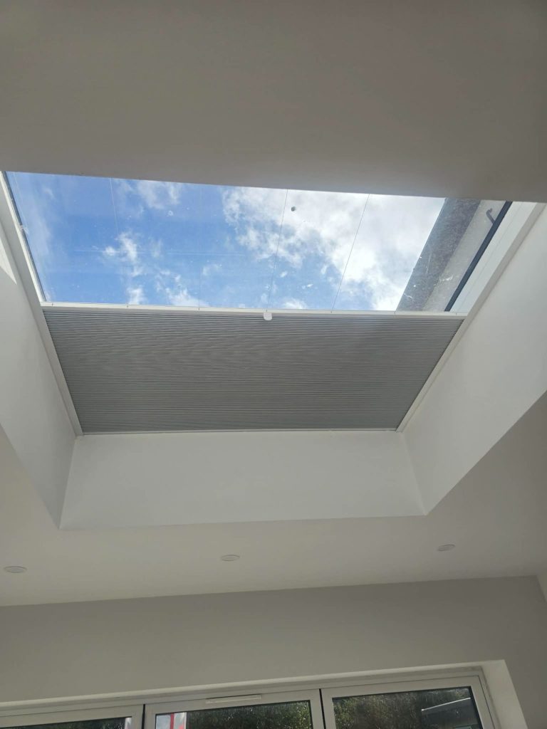 Tensioned skylight blind system Tensioned skylight blind system installed inside a glazed extension to provide smooth operation, light control and a clean finish