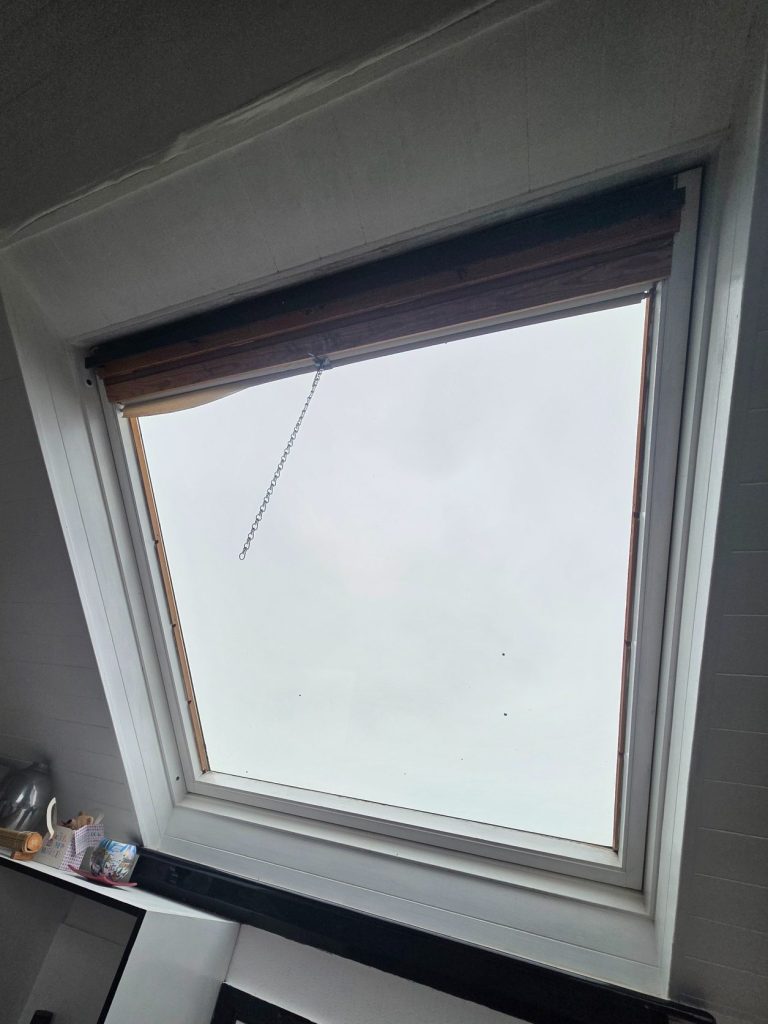 Old Velux roof window blind replacement Older Velux roof window in Raunds before removal of the original notched side channels and obsolete blind system