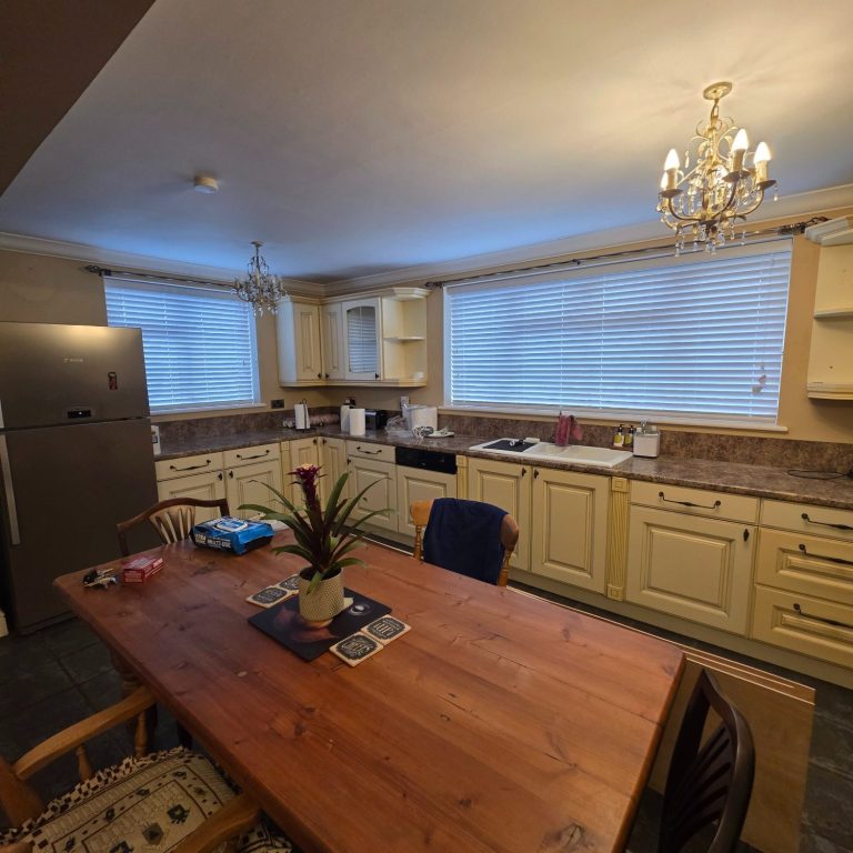 Fauxwood 50mm venetians Fauxwood Venetian blinds fitted in a classic farmhouse kitchen to provide a clean, practical finish with easy light control