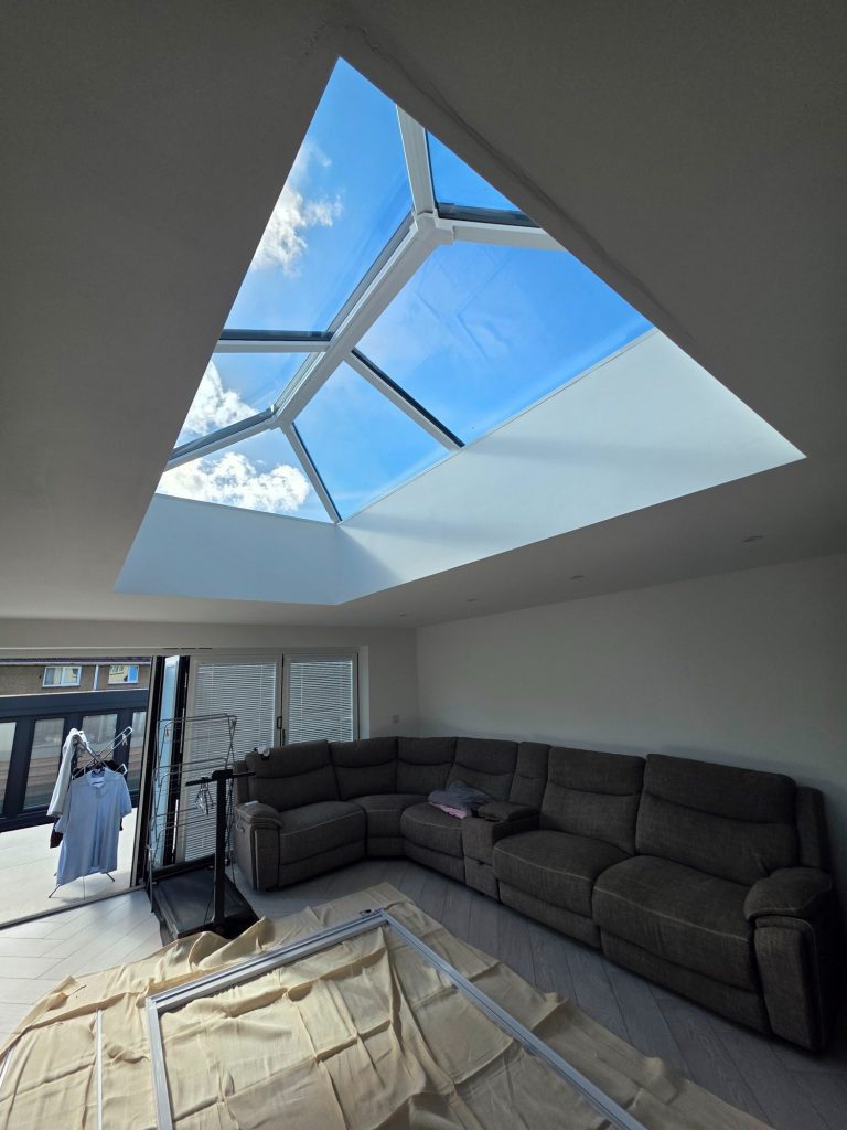 Roof Lantern Blind Assembly & Floor Protection | TrueShade Interiors Made-to-measure solar powered roof lantern blind being assembled in a Corby living room, with protective floor coverings laid during install