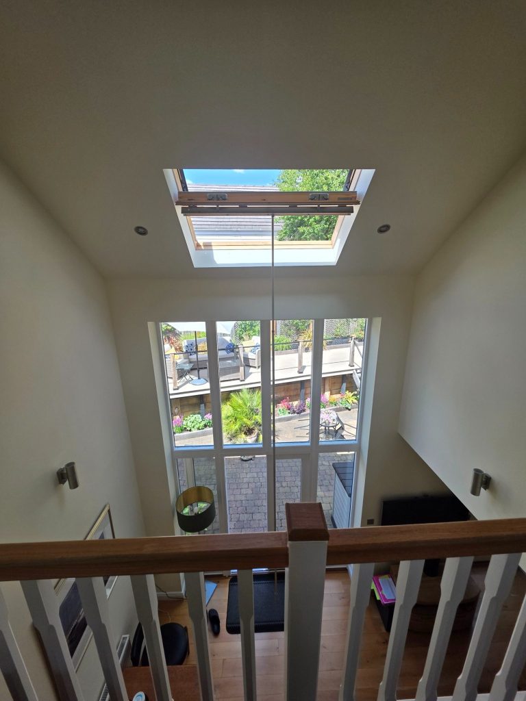 High-Level VELUX Solar Blind Installation | TrueShade Interiors VELUX roof window positioned high above a staircase in Great Oxendon, Northamptonshire, requiring specialist access for solar blind